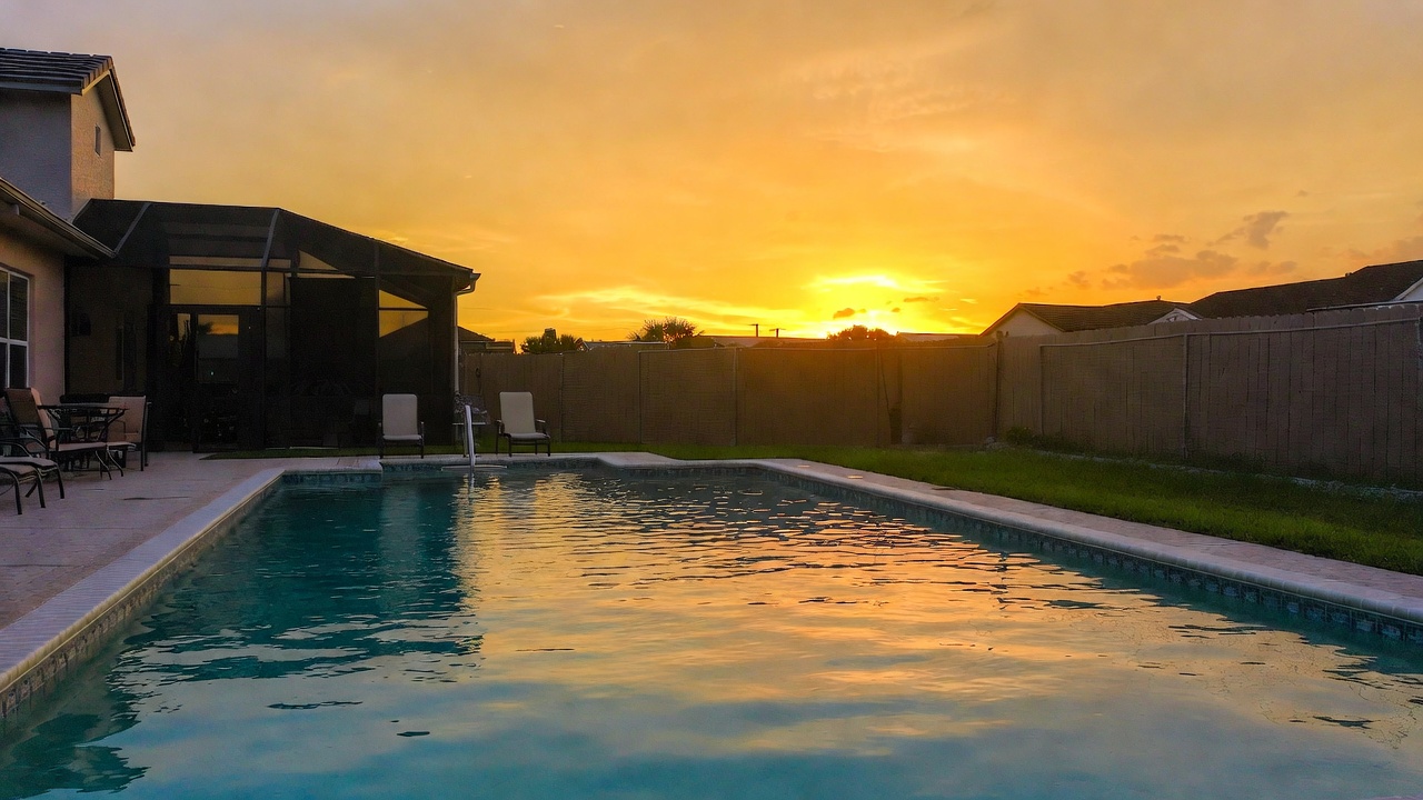 Beautiful backyard pool at sunset with golden hour light in Florida